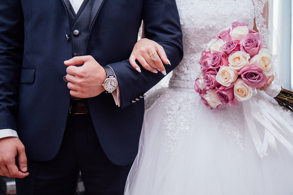 A groom and bride locking arms