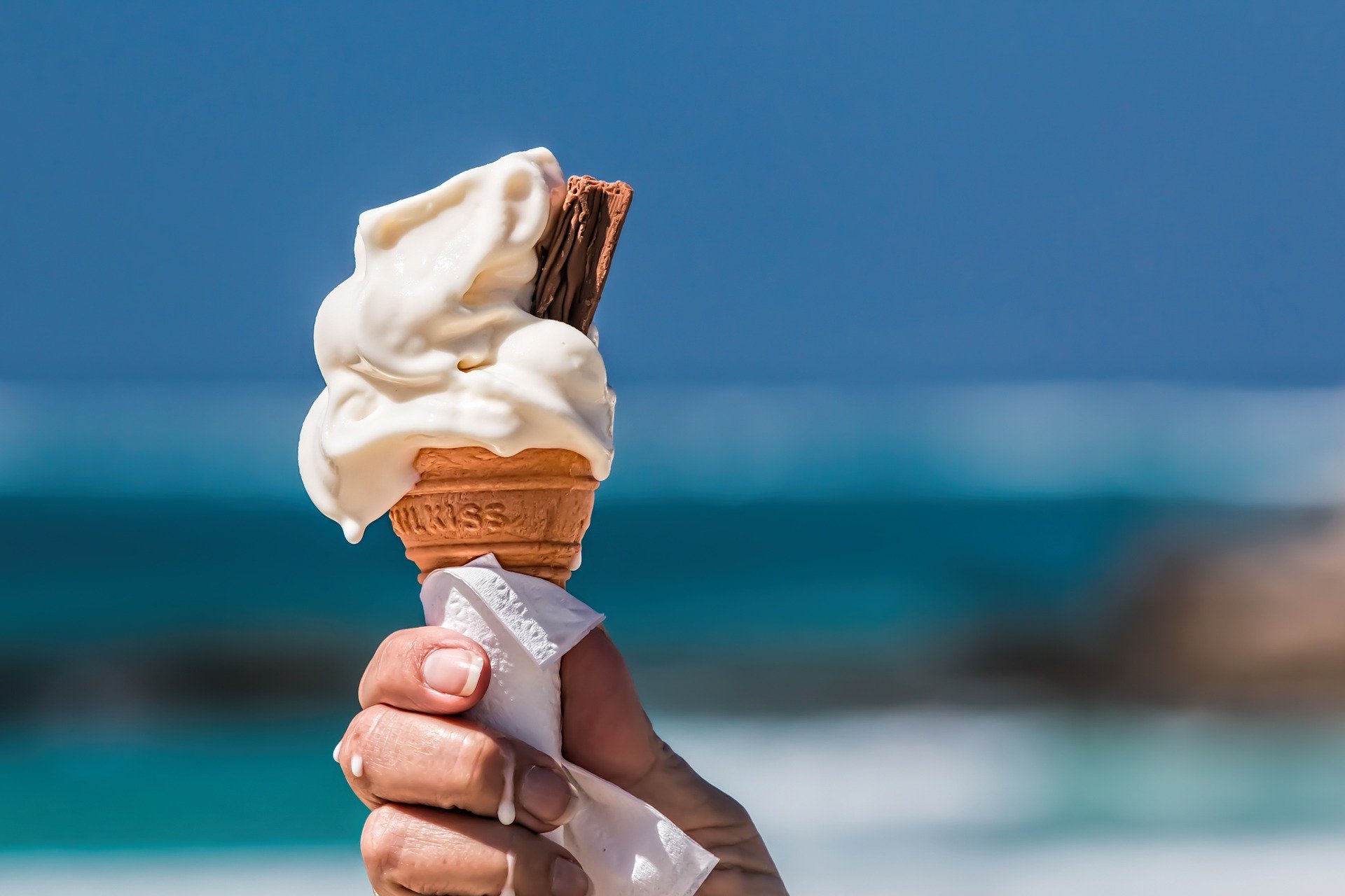 An ice cream cone with a beach background